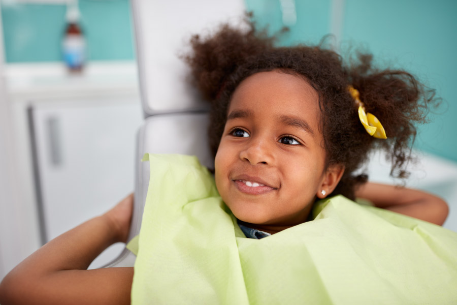 Young smiling girl in the dental chair.